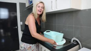 She Spent Her Whole Sunday Emptying Buckets Inside the Pink Roadhouse. The Water Didn't Care.